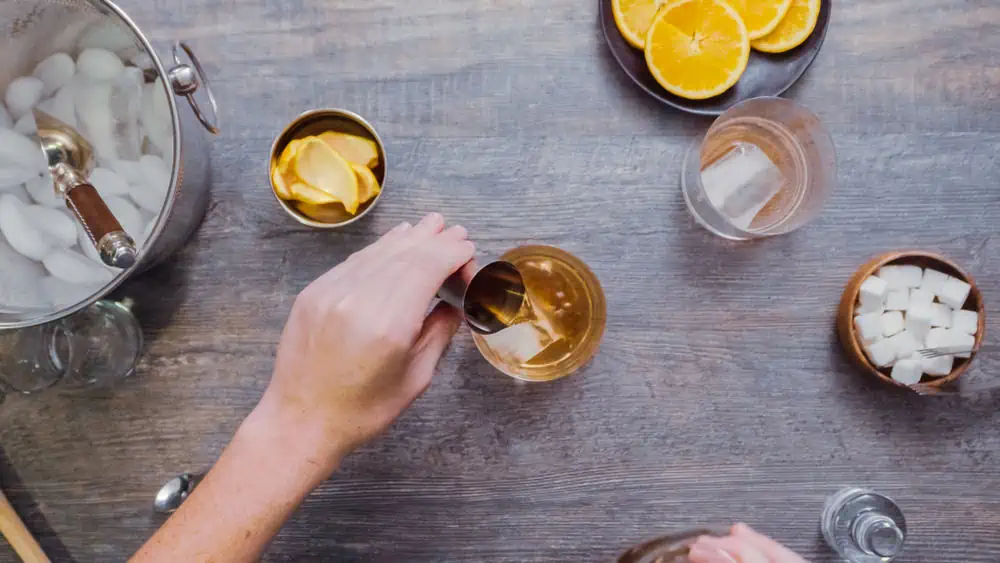 person making cocktails at home