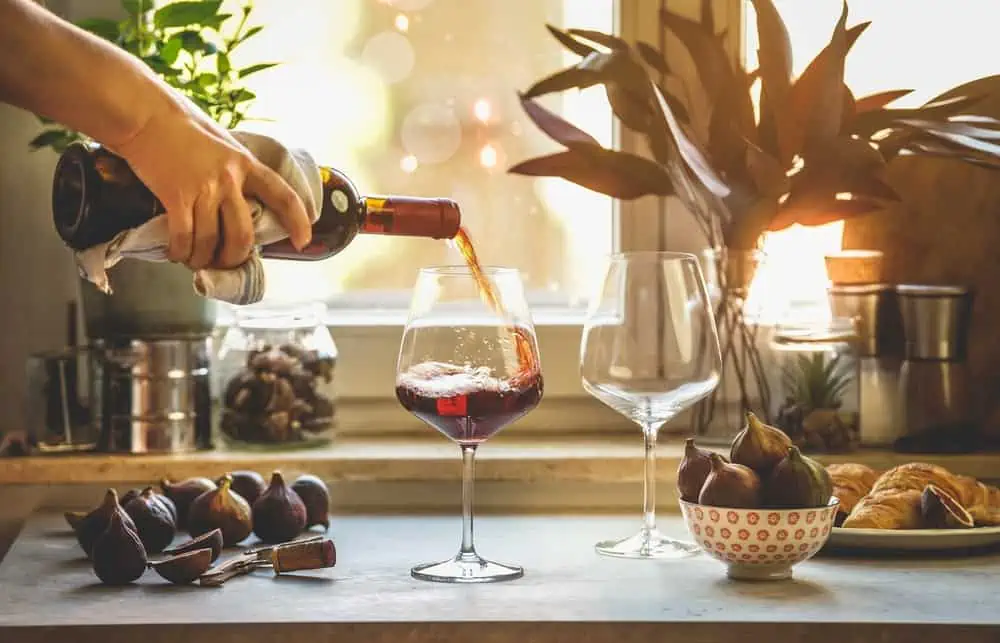 red wine pouring into a glass