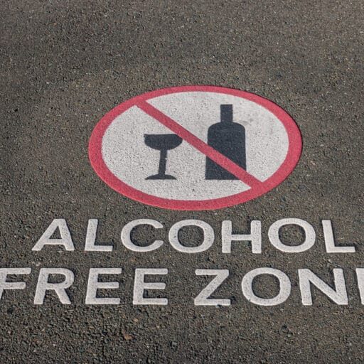 Closeup,Of,Alcohol,Free,Zone,Sign,On,Pavement